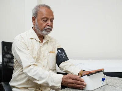 A patient checking in with a clinician at a front desk